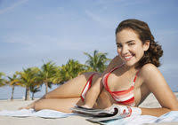Create a free profile to get unlimited access to exclusive videos, sweepstakes, and more! Outdoors Day Leisure Activities Lying Down One Person Only Relaxation Enjoyment Half Length Smiling Side View Listening Music Girl Mp3 Player Vacations Swimwear Bikini Holiday Maker Teenager Sandy Beach Sand Selective Focus