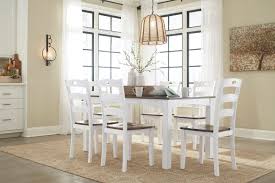 The sturdy metal base is made of curved legs and includes a small circular shelf. The Woodanville White Brown Dining Room Table Set 7 Cn From Signature Design By Ashley Is Available At Beaver S Furniture In Kennewick Wa