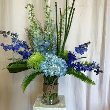 Pairing Shades Of Blue With Greenery Makes For A Gorgeous Floral Arrangement For A Lucky Person Flower Delivery Flower Arrangements Order Flowers Online