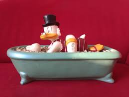 Scrooge has a great affection for his money, and his favorite hobby is to dive and swim around in the money in his bin. Disney Statue Statuco Scrooge Mcduck In Bathtub Catawiki