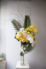 Tall And Structural Grouped Floral Arrangement For A Corporate Event Yellow Roses An Modern Floral Arrangements Unique Floral Arrangements Flower Arrangements