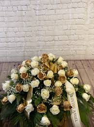 Filler flowers make any arrangement look more professional. White Gold Rose Casket Spray By Leo S Metropolitan Florist
