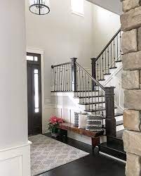 For this style you will need two spindles on each tread. Neutral Modern Farmhouse Foyer With Wainscoting Stained And Painted Stairs House Stairs Staircase Design Farmhouse Foyer
