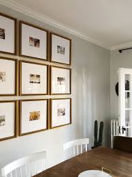 This dining room is decorated with an eclectic art gallery along with a lovely white chandelier that hung from the beamed ceiling. The Half Wall Grid Gallery Wall For 5x7 Photos Framebridge Gallery Wall Living Room Framebridge Gallery Wall Picture Gallery Wall