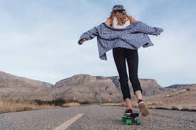 Focuses on the basics of foot placement, pushing and riding on the skateboard. Young Girl Riding A Skateboard In The Street By Paff Girl Skater