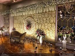 The floral backdrop will look incredible with any theme and create a wall of flowers that will wow your family and friends. White Floral Wall In 2020 Wedding Decor Inspiration Floral Wall Indian Wedding Decorations