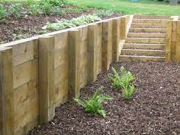 Wood and concrete block are two of the most common materials. Timber Retaining Wall Post Distance Google Search Wooden Retaining Wall Sloped Garden Wood Retaining Wall