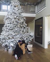 The youngest sisters in the group, kendall and kylie jenner, showed off their christmas glam looks in for kendall, it was a beauty shot in front of a stark white christmas tree. Kylie Jenner And Tyga Cuddle In Front Of The Christmas Tree In Adorable Photo All I W Cool Christmas Trees Big Christmas Tree Beautiful Christmas Decorations