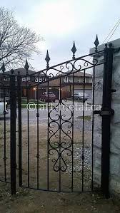 Metal black spokes attached to a metal frame to form this modern and sleek fence and gate combi. Elegant Aluminum Gate Design Ideas To Improve House Entrance