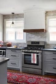 Light Gray Raised Panel Cabinets Are Accented With Oil Rubbed Bronze Pulls And A Charcoal Gray Quartz C Grey Kitchen Cabinets Grey Countertops Kitchen Cabinets