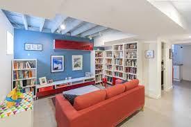 Create a family library with a bookshelf, comfortable chairs and task lighting. Basement Library Houzz
