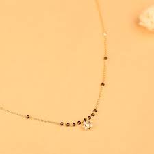 Quantities of indian beads from archaeological sites in the subcontinent, as well as early icons, reliefs on friezes, and literary texts, affirm that beaded jewelry has always been important to all classes of indian society: Archa Mangalsutra Jewellery India Online Gold Jewellery Design Necklaces Gold Mangalsutra Designs Black Beads Mangalsutra Design