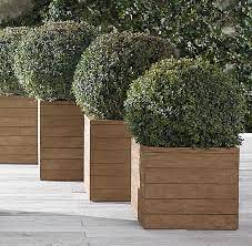 Planter boxes are perfect for container gardening, and can bring style to your outdoor space. 10 Easy Pieces Square Wooden Garden Planters Gardenista Wooden Garden Planters Outdoor Planters Large Garden Planters
