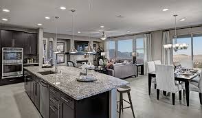 The New Henderson Nv Home Is Anchored By A Bright Open Kitchen With Granite Countertops And Stainless S Home Kitchens Log Home Kitchens American Home Design