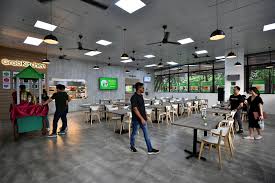 Gojek drivers wear jackets with the new logo on monday. After Grab Gojek Has Launched 20 Cloud Kitchens