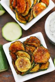 Calories per serving of zucchini parmesan crisps 32 calories of olive oil, extra virgin, (0.25 tbs) 27 calories of parmesan cheese, grated, (0.06 cup) 26 calories of bread crumbs, dry, grated, plain, (0.06 cup) Crispy Baked Zucchini Chips Snack Recipe Scrambled Chefs