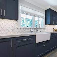 A beautiful quartz countertop follows the lines of the white cabinetry and the light blue island. Pin On White Kitchen Trends