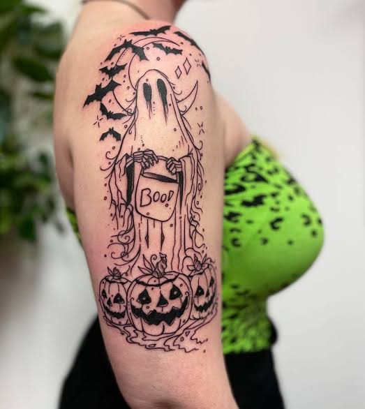 Vibrant Halloween-inspired tattoo sleeve featuring a ghost, glowing  jack-o'-lantern, and bold floral elements. The bright pink flowers contrast  beautifully with the deep purples and eerie tones, creating a playful yet  striking full-arm