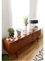 The center of a living room is often filled with sofas, armchairs, area rugs and coffee tables, so use the room's corners to create individual nooks. Mid Century Modern Credenza With Images Dining Room Design Mid Century Dining Room Retro Home Decor