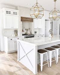 White Kitchen Design With Natural Wood Floors And Gold Pendant Lights Please Follow Save Repin Fo White Kitchen Design White Kitchen Decor Kitchen Design