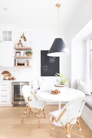 A Black Conical Light Illuminates An Ikea Docksta Table Seating Two Serena Lily Riviera Side Cha In 2020 Ikea Dining Room Brown Wood Dining Table White Dining Chairs