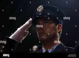 New York, New York, USA. 4th June, 2014. Firefighter EUGENE SQUIRES of  Ladder Company 13 salutes during FDNY Medal Day 2014 at the 69th Regiment  Armory in New York City, New York.