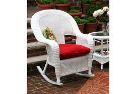 Matching wicker side table features curved legs and bottom shelf. Malibu Resin Wicker Rocking Chairs