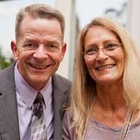 Kim Donovan reads a volunteer appreciation award alongside