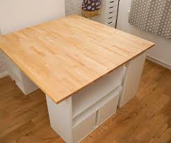 There are also kitchen cabinets towards the wall for a small pantry and hung up high for closed storage. Diy Huge Sewing Table For A Craft Room