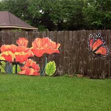 This black fence clearly marks the seating area. 15 Stunning Fence Painting Designs To Inspire Your Own Backyard