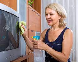 Mature Woman Cleaning TV With Cleanser At Home Stock Photo, Picture and  Royalty Free Image. Image 34146445.