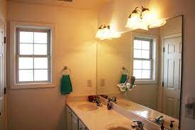 Updating The Bathroom Light Fixture Bathroom Lighting Bathroom Light Fixtures Brass Bathroom Lighting