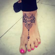 The watercolor style makes this wrist tattoo colorful and attractive. Mandala Tattoo On Left Foot By David Torres