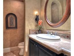 Give the vanity top or even its sides a faux stone treatment such as marble using several paint colors and a clear glaze. Mediterranean Powder Room With Faux Painted Walls Faux Painting Walls Faux Walls Italian Style Decor