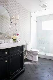 Herringbone can be seen in industrial, modern, and contemporary spaces, and even in some farmhouse designs. Black Porcelain Herringbone Bathroom Floor Tiles Design Ideas