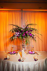 Tropical Purple And Palm Tree Leaf Centerpiece Tree Centerpieces Palm Trees Wedding Palm Wedding