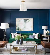 Rich Blue Walls Work Harmoniously With A Deep Green Couch And Neutral Colours Photo Studiomcgee Re Green Sofa Living Room Green Sofa Living Living Room Paint