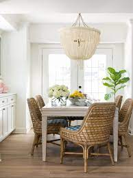 A boho living room features furniture draped in layers of textured textiles. Neutral Dining Room With Boho Chic Chandelier Hgtv