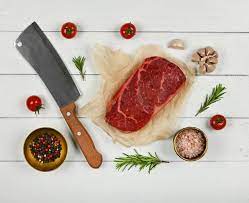 Peppercorn is the perfect pepper to spice up your steak. Premium Photo Close Up One Marbled Raw Sirloin Beef Steak On Brown Paper With Cleaver Knife And Spices Over White Wooden Table Elevated Top View Directly Above