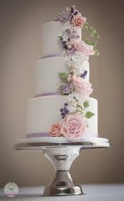 Textured white wedding cake with purple or pink flowers. Wedding Cake With Handmade Blush Pink Roses Lavender Greenery And Lilacs Lavender Wedding Cake Pink Wedding Cake Blush Pink Wedding Cake