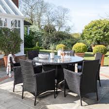 Synthetic rattan is the perfect material for garden dining furniture. Kemble 6 Seater Rattan Round Dining Table Set In Black Rattan Garden Laura James