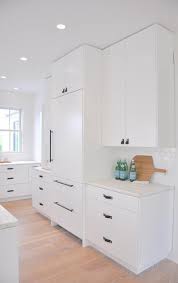 Black Leather Tab Pulls Beautifully Contrast White Flat Front Cabinets Finished With A Honed White M Black Kitchen Handles Leather Pulls Kitchen White Cabinets