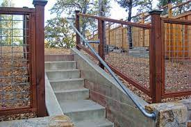 While you could use wrought iron, you might be able to get a railing made to match the fencing around the upper part. 15 Customer Railing Examples For Concrete Steps Simplified Building