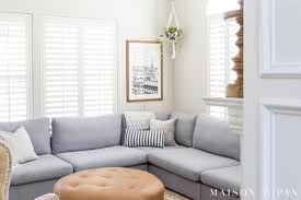 In this space from 2id interiors, a sleek floor lamp is paired with a white leather chair to fill up the corner space and complement the midcentury modern vibes of the room. How To Decorate A Living Room With A Sectional Maison De Pax