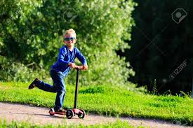 Little boy with his scooter and safety helmet Little Boy Riding Scooter In Summer Nature Stock Photo Picture And Royalty Free Image Image 61271381