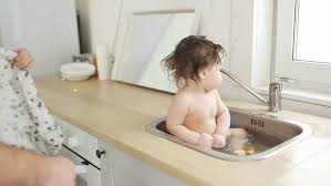 If your baby doesn't like showers though and a baby's bath won't fit in your shower recess, consider the kitchen sink. Baby Taking Bath In Kitchen Stock Footage Video 100 Royalty Free 30683623 Shutterstock