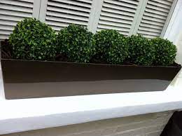 While it's easier than ever to buy live plants online, sometimes, despite our best intentions, those live plants become, well, dead plants. Box Topiary Balls Fake It Modern Planters Outdoor Window Box Plants Artificial Plants Outdoor