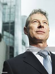 Businessman Outdoors Smiling Low Angle View High-Res Stock Photo