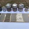 Accent colors include a deep brown range hood, black kitchen island, and deep grey marble countertops. 3