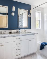 Navy blue washstand with a white quartz countertop in a kid's bathroom featuring beadboard walls and caged sconces flanking an oval rope mirror. Navy Blue Bathroom Ideas Houzz